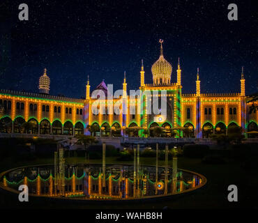 Night photo of Tivoli Garden park in central Copenhagen. It's a fabulous world of thousands of colorful lights. It is an amusement park with roller Stock Photo