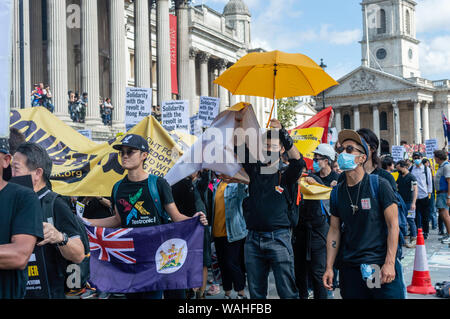 Protesters walking in a line at the UK Solidarity with Hong Kong rally. Stock Photo