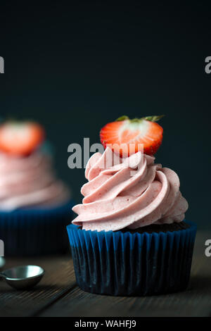 Chocolate cupcakes with strawberry meringue butter cream Stock Photo