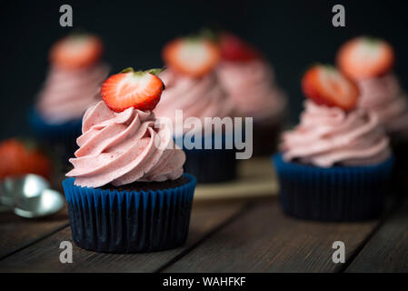 Chocolate cupcakes with strawberry meringue butter cream Stock Photo