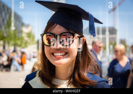Chinese student wearing graduation cap and gown, Birmingham UK Stock Photo