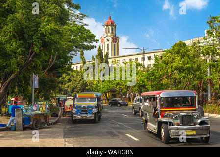 street view of manila with jeepney and clock tower Stock Photo