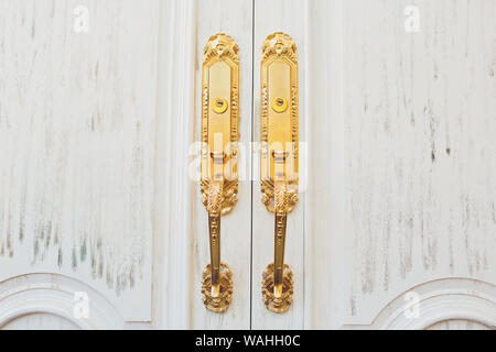 Close up of classic golden door handle on white door Stock Photo