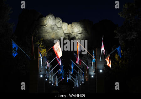 Mount Rushmore National Memorial, evening lighting ceremony, Avenue of Flags, South Dakota, United States, by Bruce Montagne/Dembinsky Photo Assoc