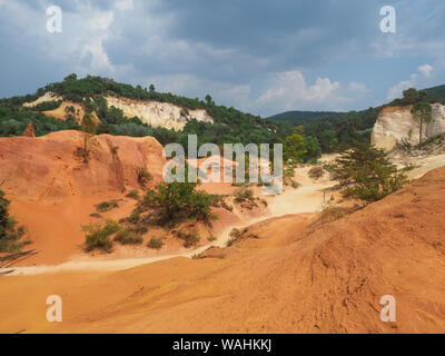 Provence Colorado. Walks in strange desert scenery with yellow red rock formations in former ocher-mining quarries. Rustrel, France. Colorful valley. Stock Photo