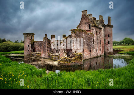 Back view of moated triangular Caerlaverock Castle in Scotland. Back wall was destroyed in the last battle with Covenanter army in 1640, leaving the c Stock Photo