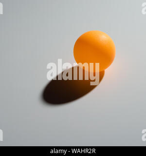 yellow pingpong ball on grey background Stock Photo