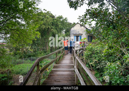 Nam Cat Tien National Park, Dong Nai Province, Vietnam, August 18, 2019: Tourists take memoris photos on wooden bridge in the nature reserve of Nam Ca Stock Photo