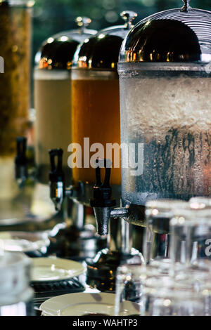 Drinking water, orange juice and tea dispenser for guests at the hotel Stock Photo