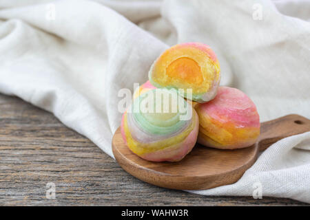 Chinese Pastry or moon cake stuffed with salted egg yolk on wood plate Stock Photo