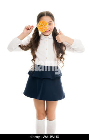 Healthy nutrition diet. Sweets reward for study. Rewarding herself with sweets. Food addictions. Girl kid eat sweet lollipop. Girl pupil school uniform like sweets lollipop candy white background. Stock Photo