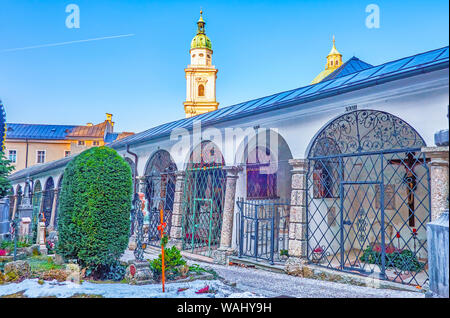 SALZBURG, AUSTRIA - FEBRUARY 27, 2019: The famous tomb arcades of St.Peter cemetery, the surrounding covered gallery with burial graves of famous fami