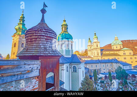 The old wooden construction with small cupola of catacombs in St Peter cemetery with a view on bell towers of Salzburg's churches, Austria Stock Photo