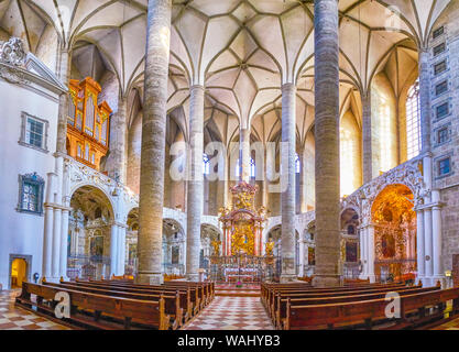 SALZBURG, AUSTRIA - FEBRUARY 27, 2019: The unique interior of Franciscan Church with high pillars stretching to the ribbed vault and  arcades around t