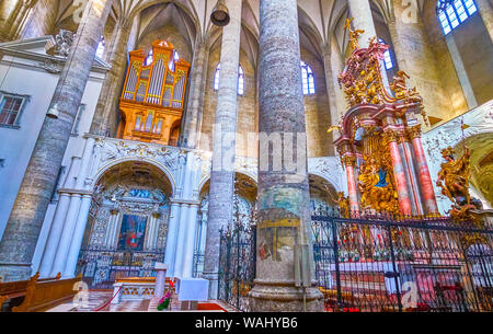 SALZBURG, AUSTRIA - FEBRUARY 27, 2019: The red marble Altar with golden sculptures of Madonna and the Child is surrounded with lattice boundary, Franc