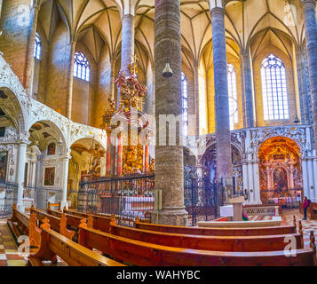 SALZBURG, AUSTRIA - FEBRUARY 27, 2019: Panoramic view on prayer hall of Franciscan Church with splendid stone Altar in the middle of Chancel, on Febru