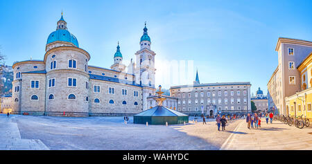 SALZBURG, AUSTRIA - FEBRUARY 27, 2019: Panoramic view on historical Old Residence, the Salzburg Cathedral and the large Residenzplatz square with wint Stock Photo