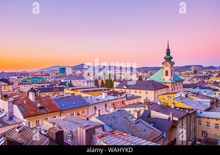 The evening view from Kapuzinenberg hill on the roofs of Salzburg's houses of Neustadt district with bell tower of St.Sebastian Church, Austria Stock Photo