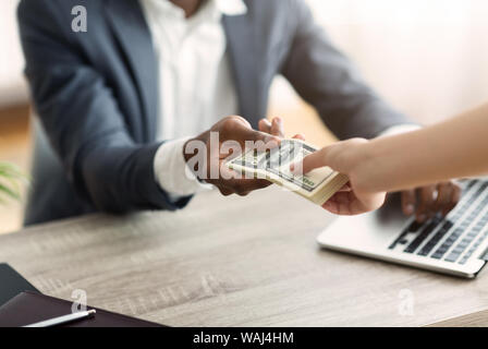 Businessman taking stack of usd dollars from his business partner. Stock Photo