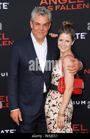 Los Angeles, CA. 20th Aug, 2019. Danny Huston, Rosie Fellner at arrivals for ANGEL HAS FALLEN Premiere, Regency Village Theatre - Westwood, Los Angeles, CA August 20, 2019. Credit: Elizabeth Goodenough/Everett Collection/Alamy Live News Stock Photo