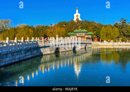 Yongan Bridge, White Stupa, Dagoba Gate, Jade Flower Island, Beijing, China. Beihai Park created 1000 AD. Stupa built in 1600's. Stock Photo