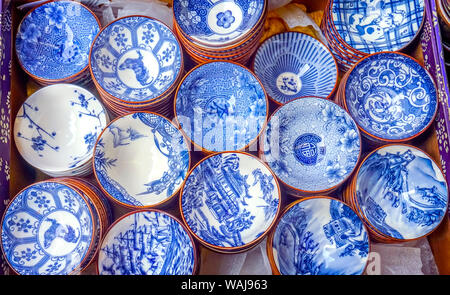 Old Chinese design blue and white ceramic plates, Panjuan Flea Market, Beijing, China. Panjuan Flea Curio market has many fakes, replicas and copies of Chinese products.
