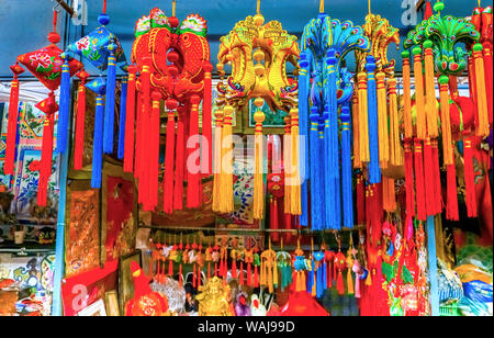 Blue, red and yellow Chinese New Year silk, Panjuan Flea Market decorations, Beijing, China. Panjuan Flea Curio market has many fakes, replicas and copies of Chinese products. Stock Photo