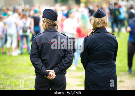 Chelyabinsk Region, Russia - June 2019: female police officers are watching the crowding. Two unidentified Russian police women in uniform monitor the Stock Photo
