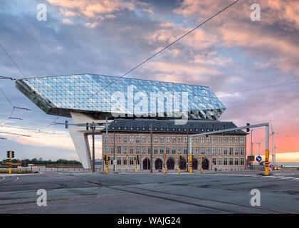 Port House Antwerp at twilight. Zaha Hadid Architects added a glass extension to a renovated fire station. Stock Photo