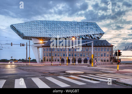 Port House Antwerp at twilight. Zaha Hadid Architects added a glass extension to a renovated fire station. Stock Photo