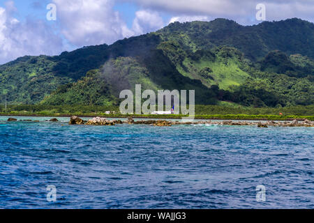Kosrae, Micronesia. Jet on runway, taking off after passengers disembarked. View is from dive boat with diver who just arrived on that jet, getting ready for first dive on Kosrae. Stock Photo