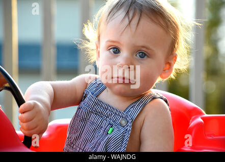 1 year old boy playing with toy truck outside (MR) Stock Photo