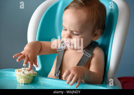 1 year old boy eating birthday cupcake (MR) Stock Photo