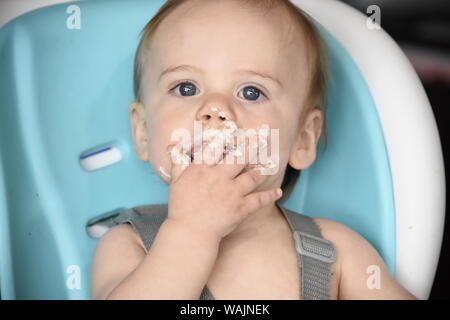 1 year old boy eating birthday cupcake (MR) Stock Photo