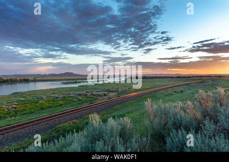 Sunrise and clouds over the Yellowstone River at the confluence with the Powder River near Terry, Montana, USA Stock Photo