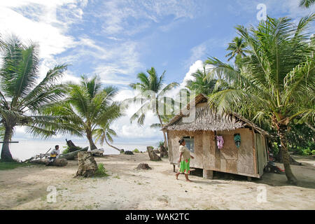 Kosrae, Micronesia (FSM). Local woman walking to her palm thatch house. (Editorial Use Only) Stock Photo