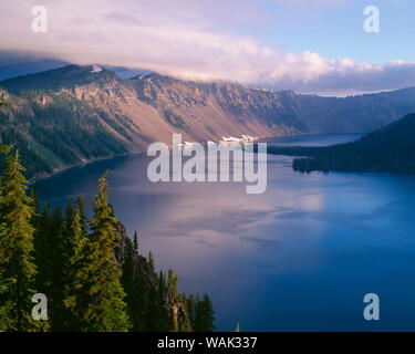 USA, Oregon, Crater Lake National Park. Morning clouds hover over west rim of Crater Lake. Stock Photo
