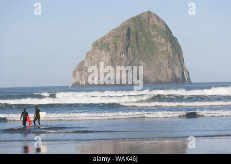 Surfers, Haystack Rock, Cape Kiwanda State Park, Oregon Coast, USA, late spring. (Editorial Use Only) Stock Photo