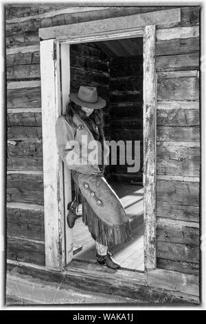 A Cowboy And His Horse By A Log Cabin Stock Photo 52709674 Alamy
