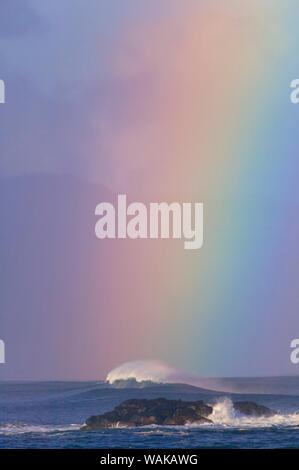Vibrant Rainbow offshore, Pacific storm waves, North Shore of Oahu, Hawaii Stock Photo
