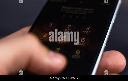 Entering a pin or secret code on a smartphone. The screen with the numbers of a modern smartphone. Stock Photo