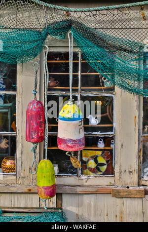 Old building, Netarts, Oregon, decorated with colorful fishing gear. Stock Photo