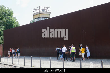 Berlin, Germany. 13th June, 2019. Many visitors come to the Berlin Wall Memorial on Bernauer Strasse every day. The watchtower rises above the rusty wall behind which the wall with the border strip, also called the death strip, is located. Credit: Annette Riedl/dpa-Zentralbild/ZB/dpa/Alamy Live News Stock Photo