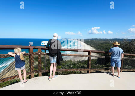 Tourists admiring the scenic view from Cape Byron over Tallow Beach, a long deserted sandy beach, Byron Bay, New South Wales, NSW, Australia Stock Photo