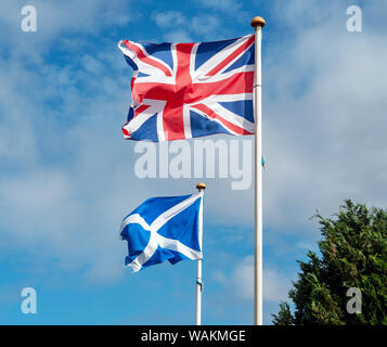 The Union Jack flying beside the Scottish Saltire at Fenton Barns, East Lothian, Scotland, UK. Stock Photo