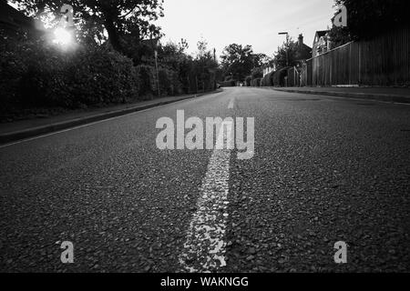 Low down view of an empty road in monochrome. Stock Photo
