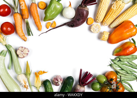 Pattern made of autumn vegetables. Food concept. Tomatoes, onion, cucumber, carrot, garlic, red beet, pepper, zucchini, maize and green haricot on whi Stock Photo