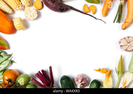 Pattern made of autumn vegetables. Food concept. Tomatoes, onion, cucumber, carrot, zucchini, garlic, red beet, pepper, maize and green haricot on whi Stock Photo