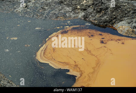 Former dump toxic waste, effects nature from contaminated soil and water with chemicals and oil, environmental disaster, contamination lagoon Stock Photo