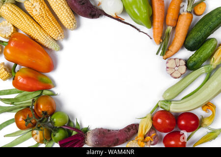 Pattern made of autumn vegetables. Food concept. Tomatoes, onion, cucumber, carrot, garlic, red beet, pepper, zucchini, maize and green haricot on whi Stock Photo